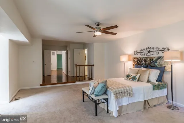 a bedroom with a bed a lamp and a chandelier