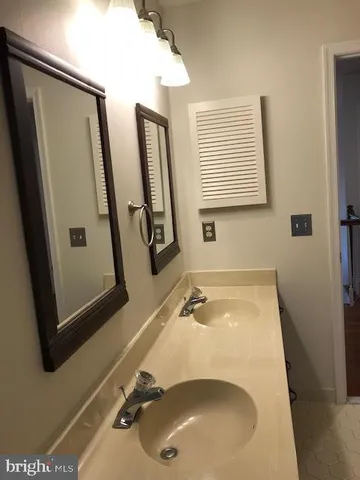 a bathroom with a tub sink and mirror