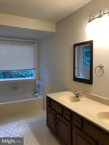 a view of a hallway with wooden floor and entryway