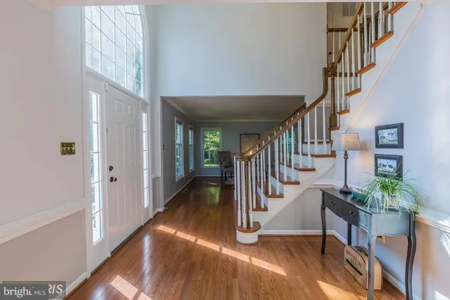 a view of entryway and hall with wooden floor