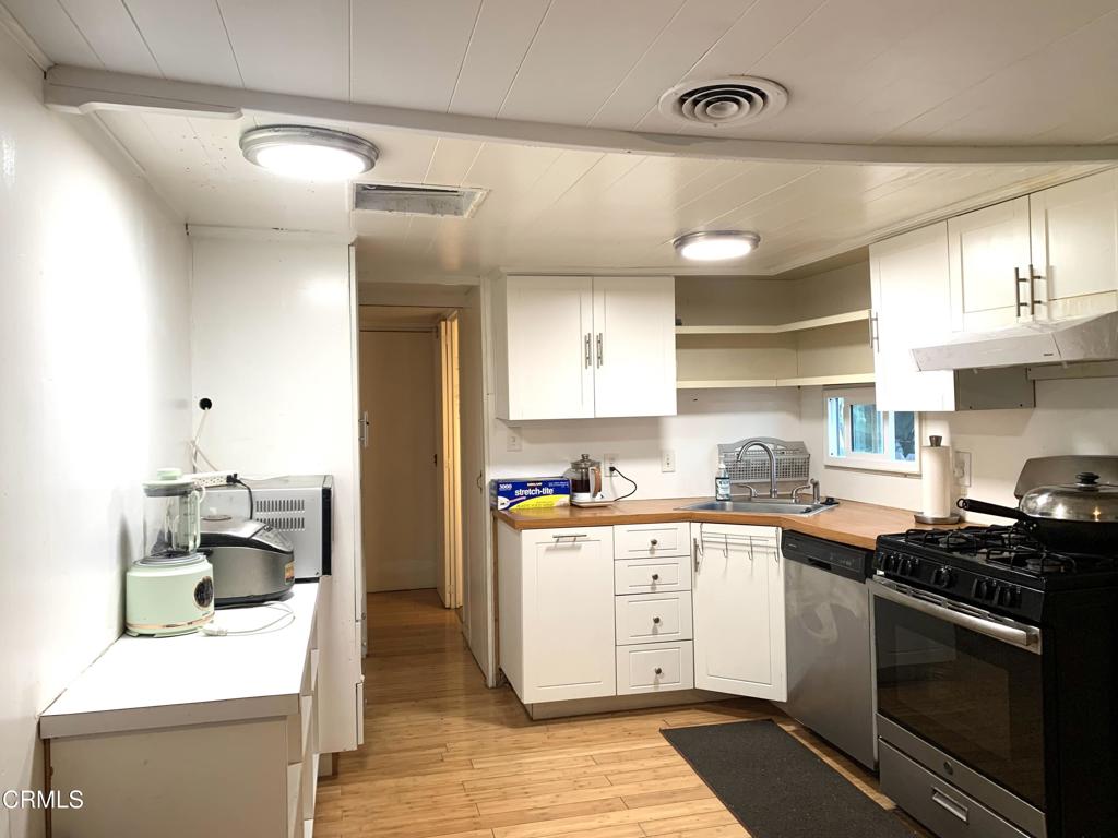 3900 East Main Street, Unit 62 Ventura, CA 93003 - Photo 3 of 11 a kitchen with stainless steel appliances granite countertop a stove and a sink