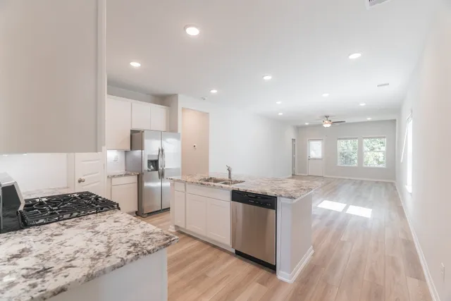 a kitchen with a sink stove and refrigerator