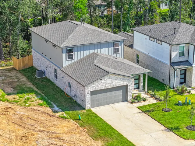 a aerial view of a house that has a yard