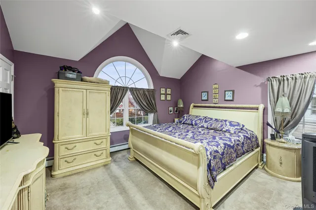 a bedroom with a bed and a flat screen tv in it