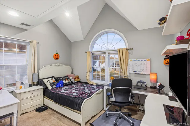 a kitchen with stainless steel appliances granite countertop a refrigerator a stove a sink a dining table and chairs with wooden floor