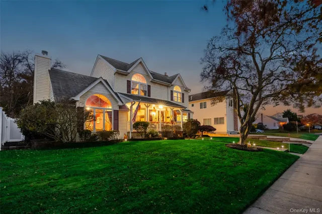 a view of a big house with a big yard and potted plants