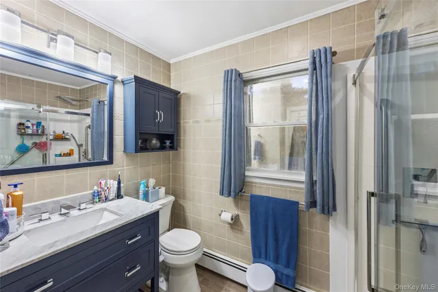 a living room with stainless steel appliances kitchen island granite countertop a sink and cabinets