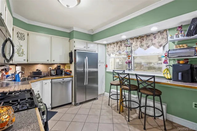 a kitchen with stainless steel appliances kitchen island granite countertop a stove and a sink