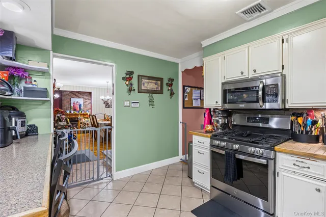 a dining room with furniture a chandelier and wooden floor