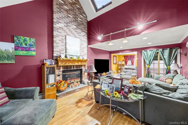 a living room with fireplace furniture and a large window