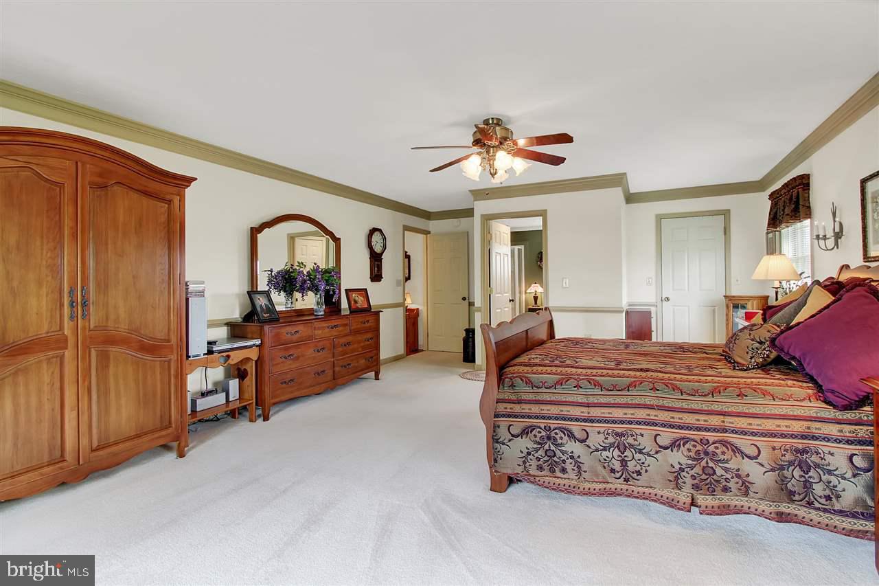 5650 Lischeys Church Road Spring Grove, PA 17362 - Photo 19 of 36 a bed room with a bed and a chandelier