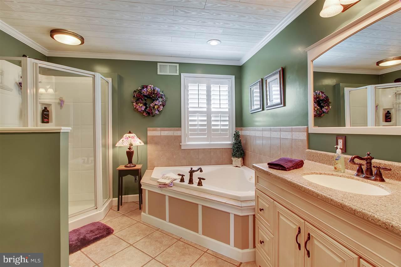 5650 Lischeys Church Road Spring Grove, PA 17362 - Photo 21 of 36 a bathroom with a tub sink and mirror