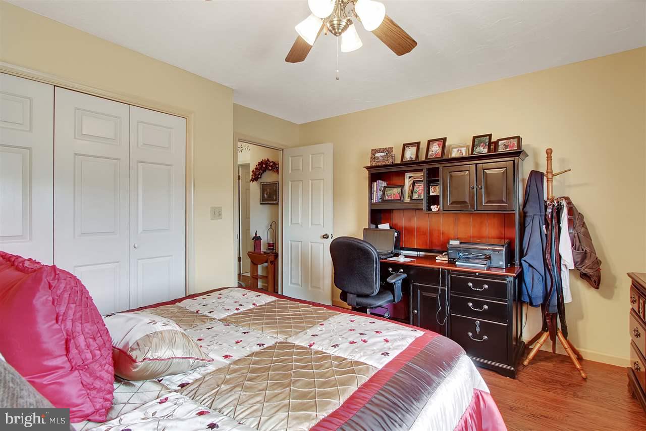 5650 Lischeys Church Road Spring Grove, PA 17362 - Photo 23 of 36 a bedroom with a bed and dresser with wooden floor