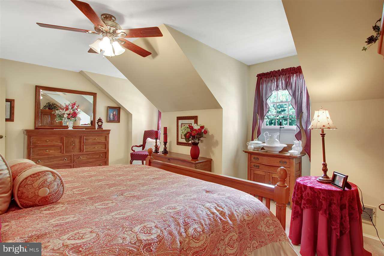 5650 Lischeys Church Road Spring Grove, PA 17362 - Photo 25 of 36 a bedroom with a bed and a chandelier