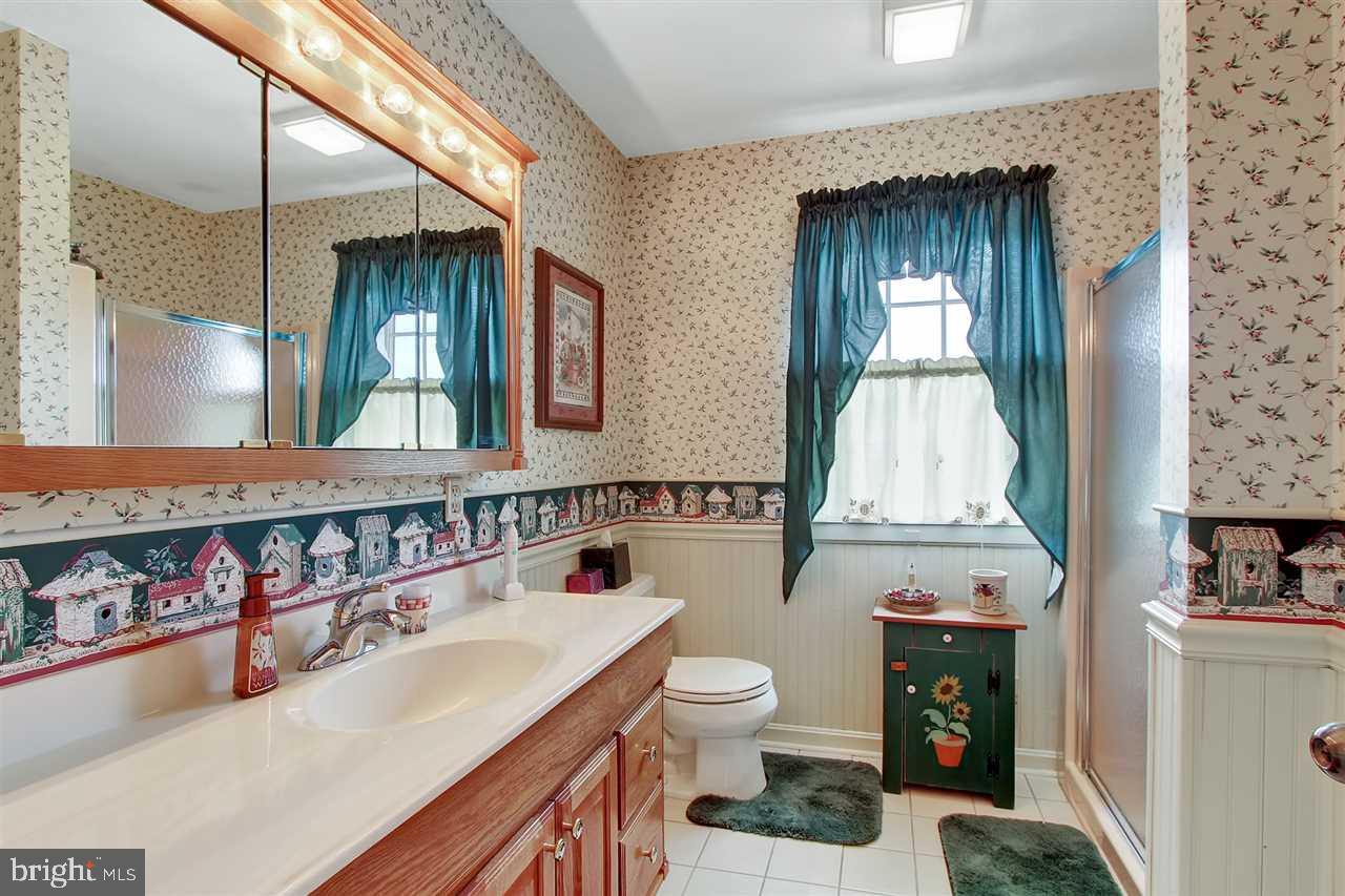 5650 Lischeys Church Road Spring Grove, PA 17362 - Photo 26 of 36 a bathroom with a sink toilet and mirror