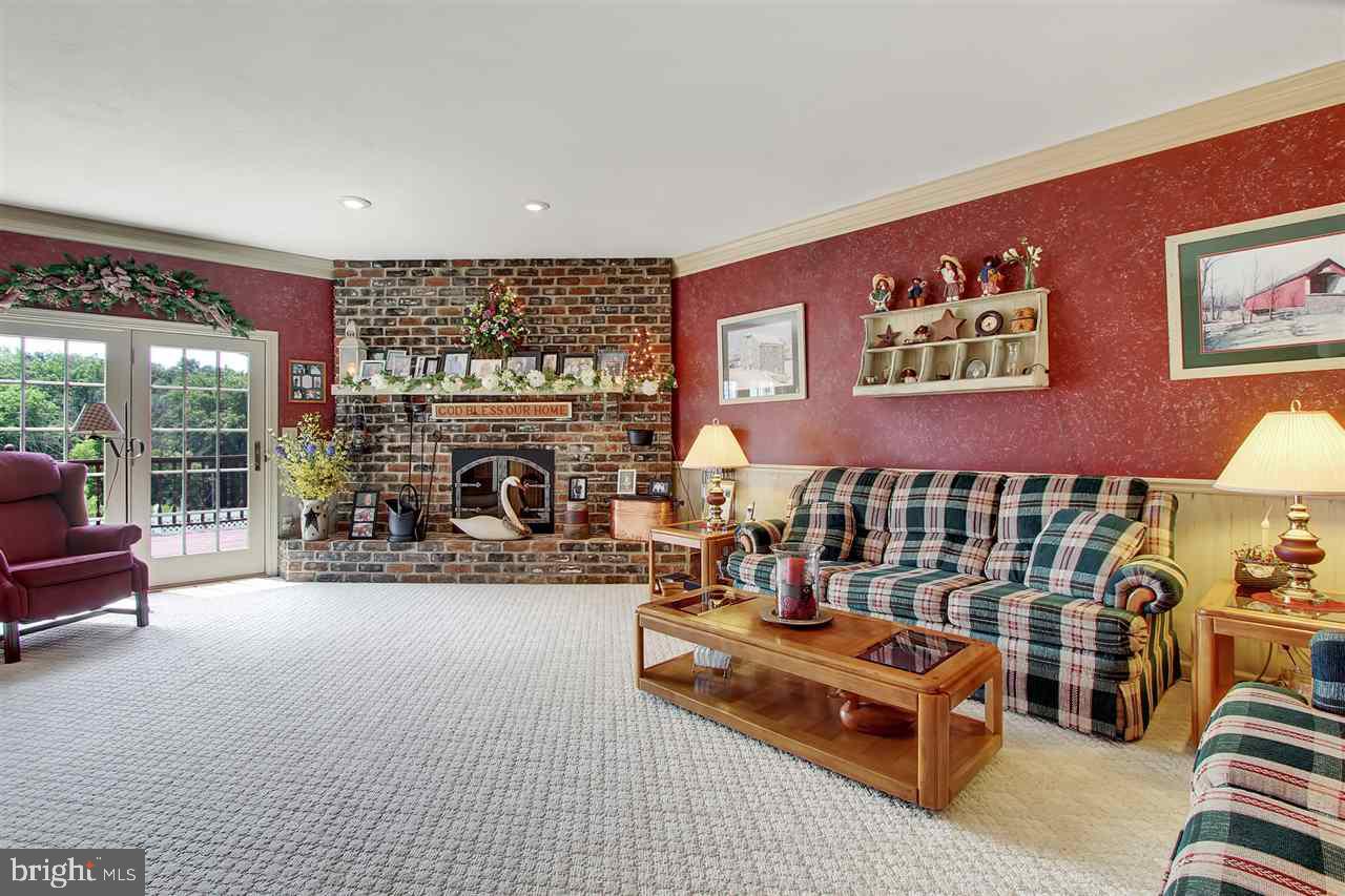 5650 Lischeys Church Road Spring Grove, PA 17362 - Photo 6 of 36 a living room with furniture gym equipment and a fireplace