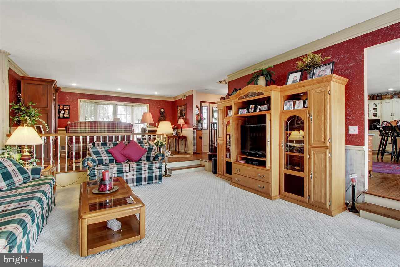 5650 Lischeys Church Road Spring Grove, PA 17362 - Photo 8 of 36 a living room with furniture a flat screen tv and large window