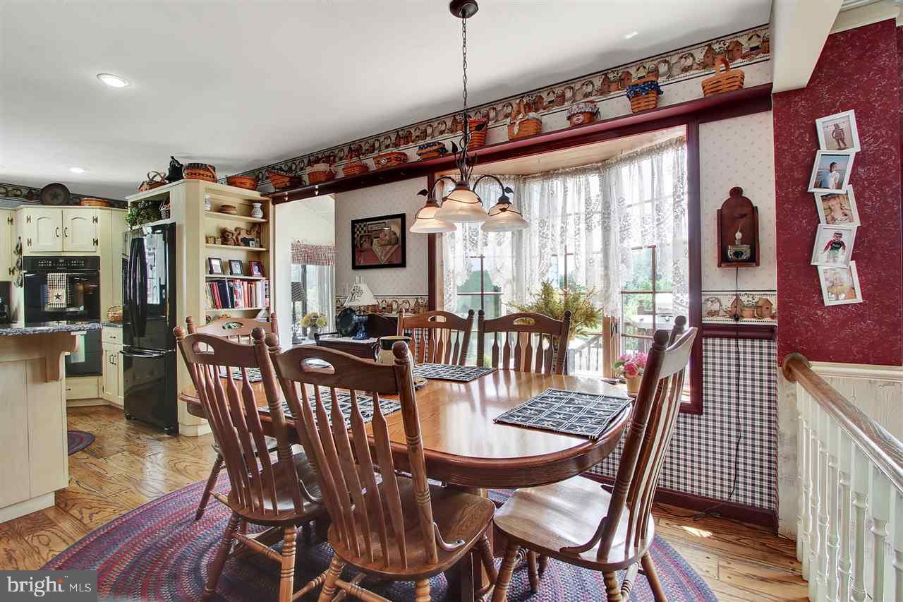5650 Lischeys Church Road Spring Grove, PA 17362 - Photo 9 of 36 a view of a dining room with furniture window and wooden floor