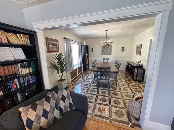 a view of a dining room with furniture and chandelier