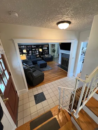 a view of empty room with wooden floor and window