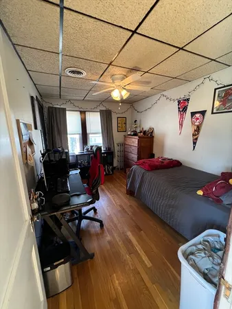 a spacious bedroom with a bed dresser and a window