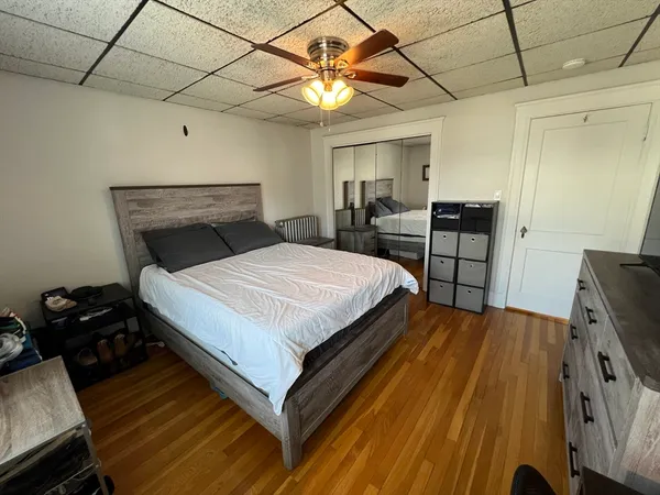 a bedroom with a bed and a window