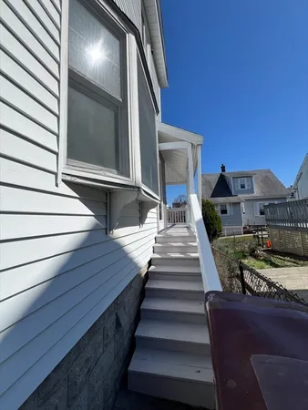 a balcony view with furniture and stairs