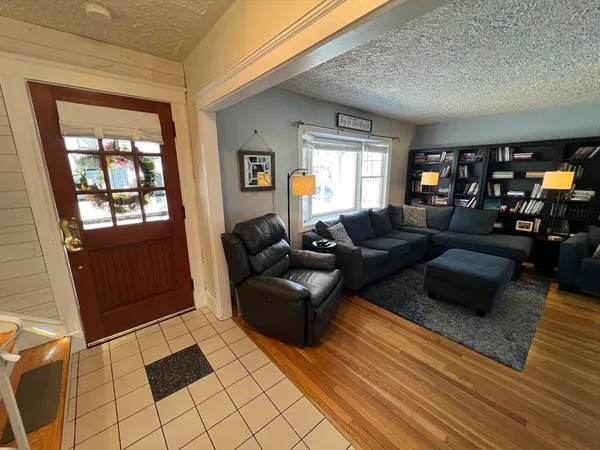a living room with fireplace furniture and a flat screen tv