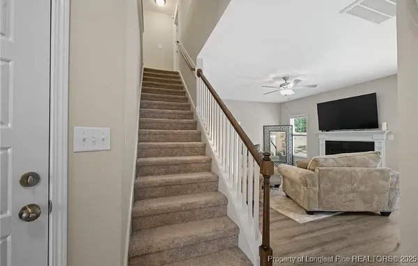 a view of entryway and hall with wooden floor