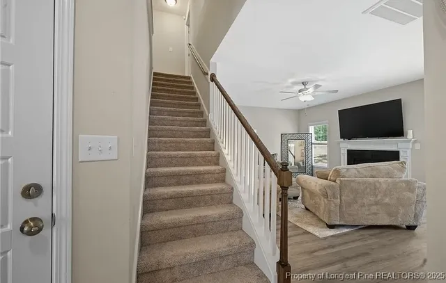 a view of entryway and hall with wooden floor