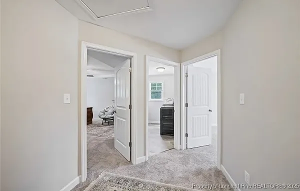 a view of a hallway with living room and dining room