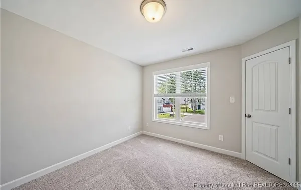an empty room with windows and garden
