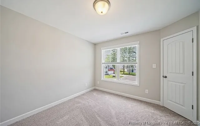 an empty room with windows and garden