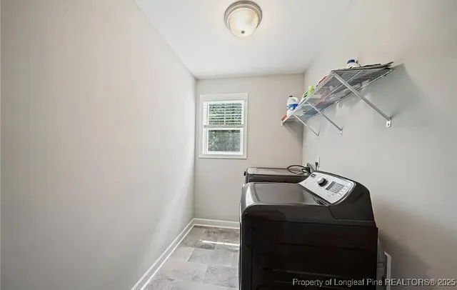 a view of storage and utility room with windows