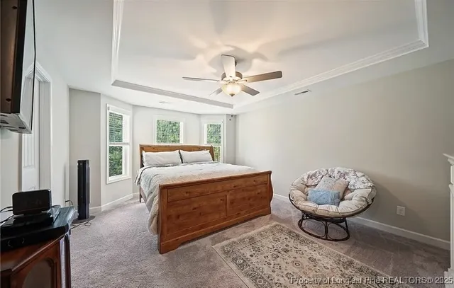 a spacious bedroom with a bed and a chandelier