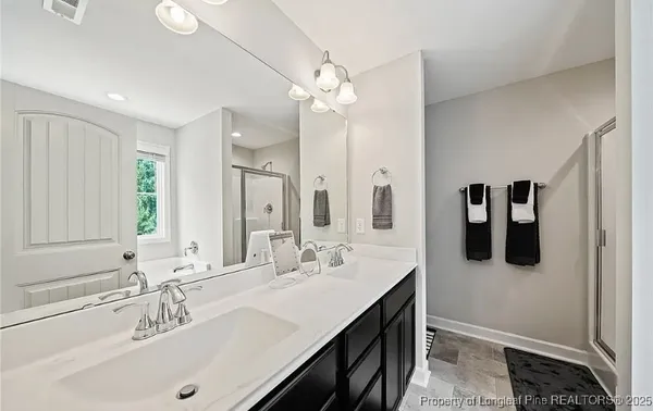 a bathroom with a sink double vanity and a mirror