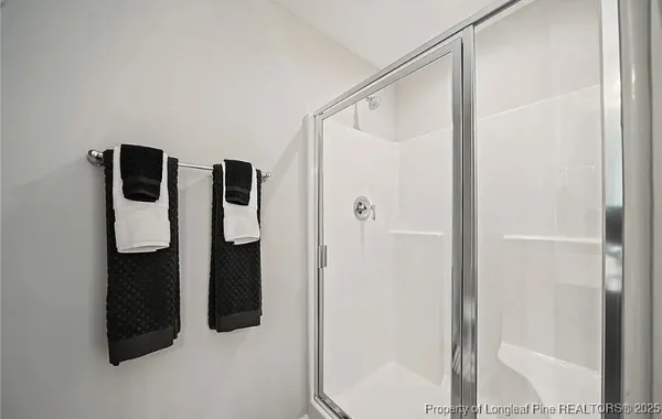 a bathroom with a shower and mirror