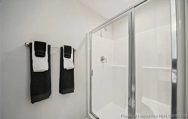 a bathroom with a shower and mirror