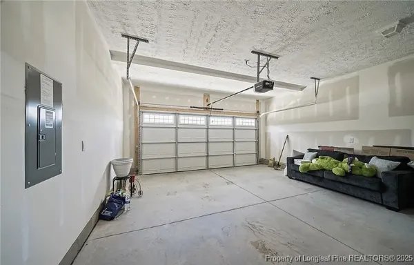 a view of a yard with furniture and wooden fence