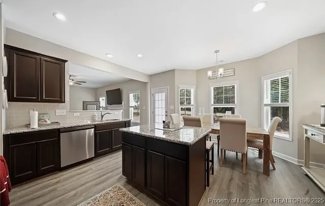 a kitchen with lots of counter top space and dining table