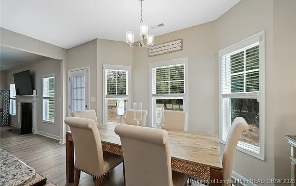 a view of a dining room with furniture window and wooden floor