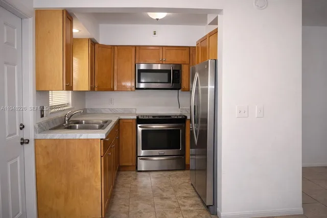 a kitchen with a sink and a stove top oven