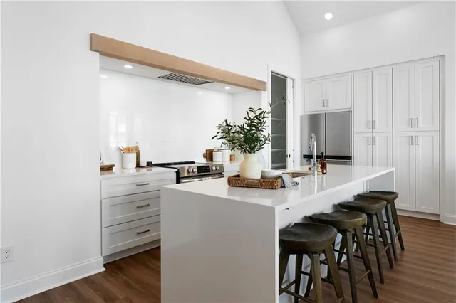 a kitchen with a table chairs refrigerator and cabinets