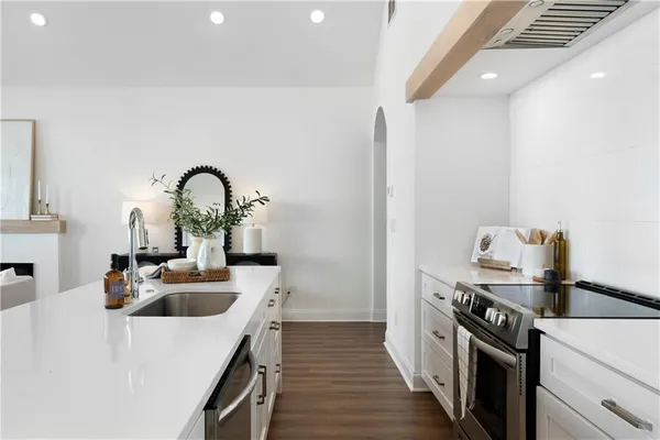 a kitchen that has a sink and a stove