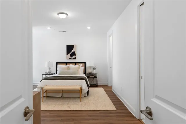 a bedroom with a bed and a mirror