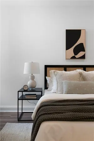 a bedroom with a bed and wall painting