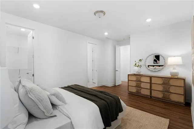 a bedroom with a bed and painting on the wall