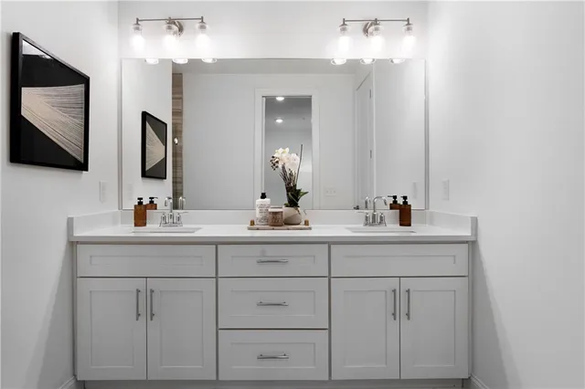a bathroom with 2 sink and a mirror