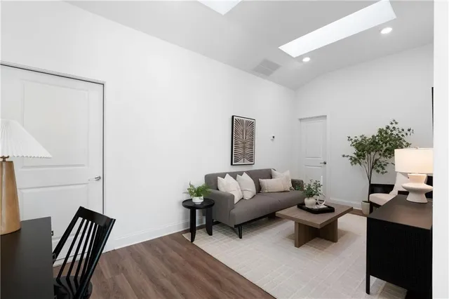 a living room with furniture and wooden floor