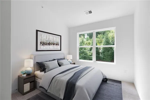 a bedroom with a bed and a window